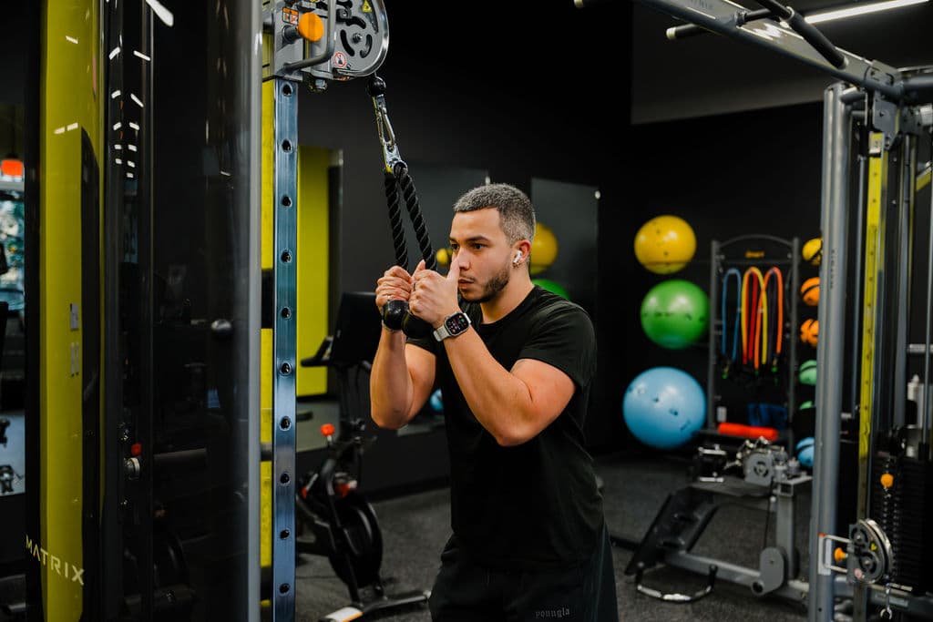 Working out at the cable machine at Metro Parc