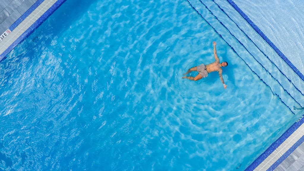 Resident floating in the pool at Metro Parc Hialeah